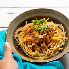 Spaghetti bolognese with parmesan cheese on white background
