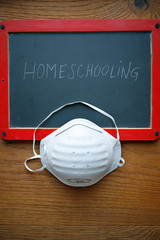 FFP2 face mask on chalkboard with homeschooling lettering