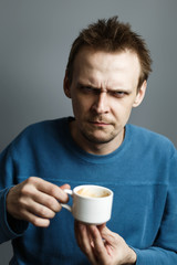 Gloom man hold cup of coffee