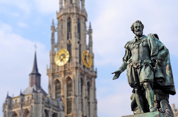 Naklejka na ściany i meble Bronze statue of the famous baroque Flemish painter Peter Paul Rubens with Cathedral of Our Lady in the back, in Antwerp, Flanders. Selective focus