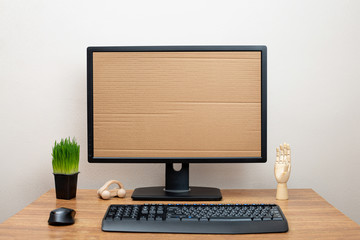 Monitor with a cardboard screen on the office desk