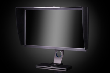 Professional photographer monitor with shading hood isolated on black