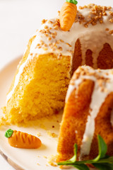 Easter lemon cake with icing and easter decoration. Easter gugelhupf cake with marzipan carrots and chocolate easter bunny