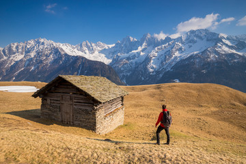 Hiker in the beauty of Alp Tombal, Soglio, Bregaglia Valley, Switzerland