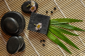 charcoal coal carbon black soap bar on a raw wood bamboo background lava stone spa skin care hygiene concept 