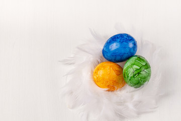 Easter eggs on white background. Colorful easter eggs in the nest