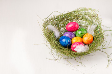 Easter eggs on white background. Colorful easter eggs in the nest