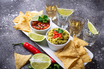 Guacamole, salsa, chips nachos and tequila