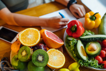 Fresh healthy green vegetables and fruits on wooden table, dieting, fitness and active healthy lifestyles concept