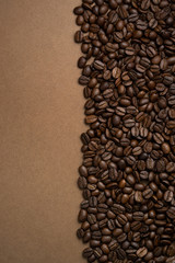 Coffee beans split the frame into two parts on a brown background