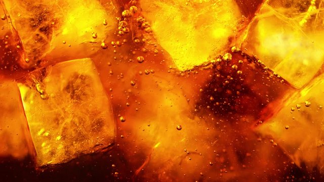 Super slow motion of pouring cola drink with ice cubes inside. Filmed on high speed cinema camera, 1000 fps.