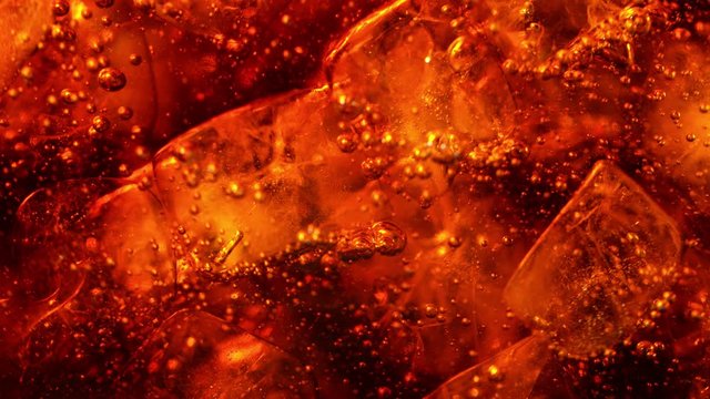 Super slow motion of pouring cola drink with ice cubes inside. Filmed on high speed cinema camera, 1000 fps.