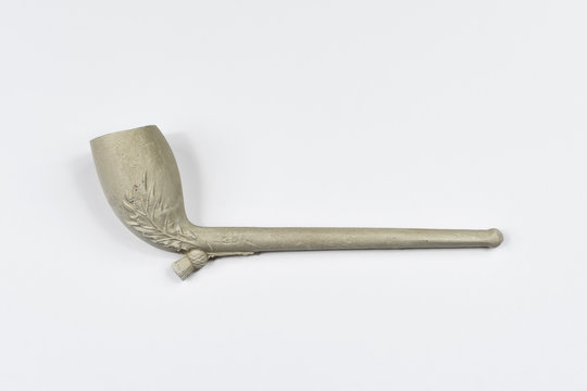 Traditional clay pipe shot side on against a white background.