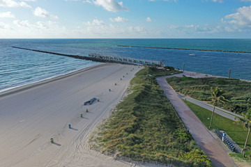 Aerial view of South Beach in Miami Beach, Florida devoid of people under coronavirus pandemic beach and park closure.
