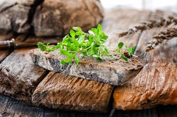 A piece of soft, fresh bread with thyme and other spices. Handmade bread close-up. Bread Story