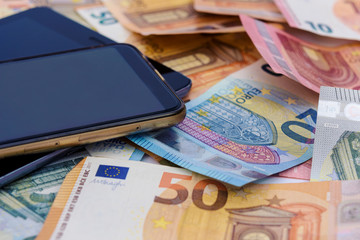 Mobile Smart phone and euro cash, digital money and fintech concept