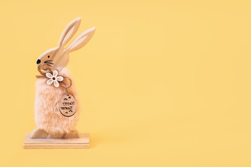 Obraz premium Wooden Easter Bunny, on an isolated yellow background