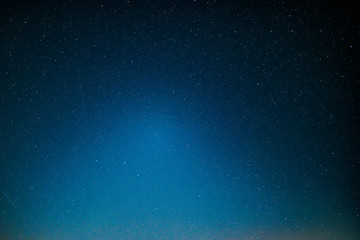 ight landscape with colorful Milky Way and yellow light at mountains. Starry sky with hills at summer. Beautiful Universe. Space background
