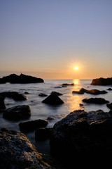 Plakat the sunset at the background in the atlantic ocean, Punta Ballena, Maldonado, Uruguay