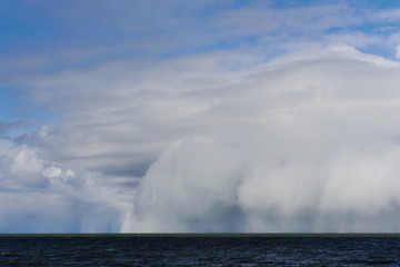 Weather is changing rapidly by the sea. Huge rain clouds are approaching.