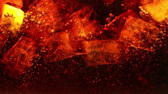 Super slow motion of pouring cola drink with ice cubes inside. Filmed on high speed cinema camera, 1000 fps.