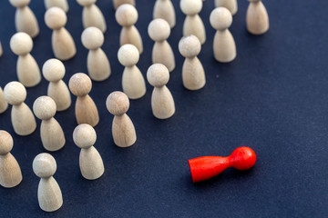 Personal development. Wooden figure in a crowd. Think different.