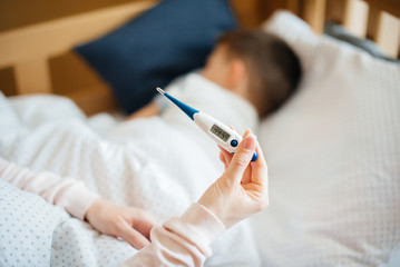 Thermometer close- up during the child's illness . The virus and the epidemic