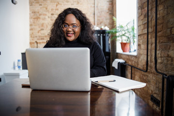 Mirthful young woman with personal laptop stock photo
