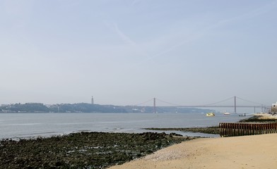 Obraz premium River Tagus in Lisbon with Cristo Rei and Ponte 25 de Abril