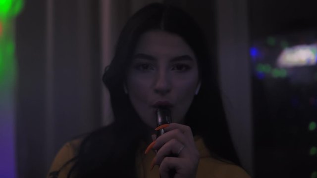 Girl smoking vape, smoke e-cigarette, opposite the mirror slow motion