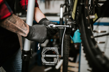 Obraz na płótnie Canvas Close up of mechanic repairing bicycles in a workshop..