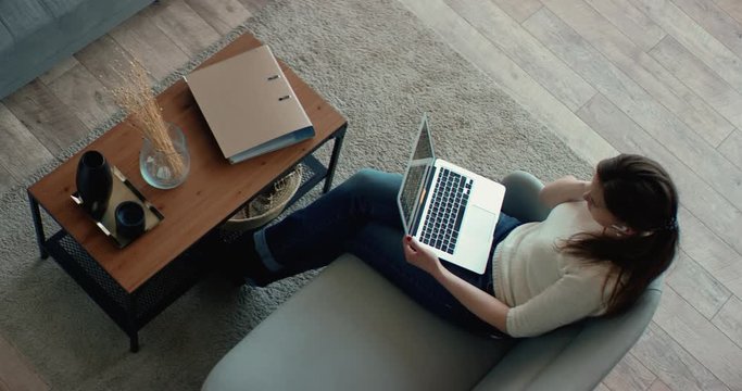 OVERHEAD Caucasian female working from home, having a video call with colleagues. Stay home, quarantine remote work. Shot on RED Dragon