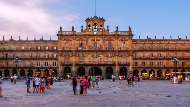 Salamanca, Spain. Crowded Plaza Mayor in Salamanca, Spain during a sunny evening. Time-lapse of motion blurred people in front of the famous landmark, zoom in