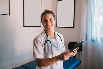 woman doctor smiling with tablet and stethoscope