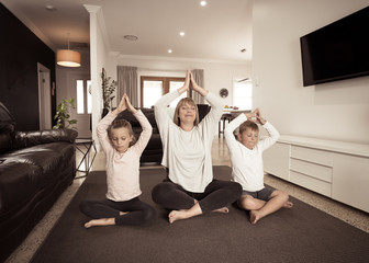 COVID-19 Outrbreak. Family doing yoga together at home during coronavirus quarantine