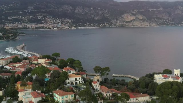 France, Saint-Jean-Cape-Ferrat, 15 December 2019: Aerial view of most expensive place in French Riviera at sunset, terraces of country houses and estates, pools, Chaise lounges, pink clouds