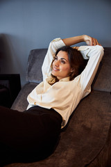 Fototapeta premium Attractive young woman resting on comfortable chair