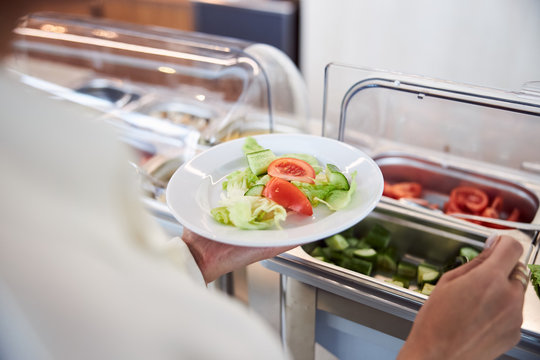 Young woman holding plate with healthy food