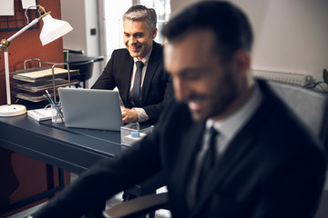Caucasian happy men are having chat indoors