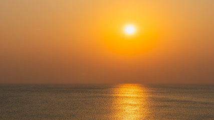 Bright sunset over the sea with refection on the sea surface..