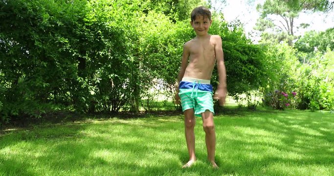 Young boy child doing the floss dance outdoors