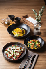 Romantic dinner in a luxury restaurant: italian meal with caprese,?ravioli and tartare