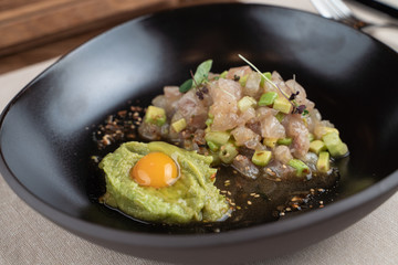 Scallop tartare with raw quail egg and avocado puree