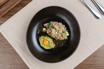 Scallop tartare with raw quail egg and avocado puree