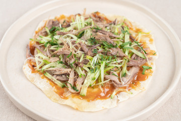 Wheat crispy tortilla with meat and greens ? a healthy snack in a cafe