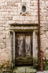 Fototapeta premium Weathered doorway in old stone wall