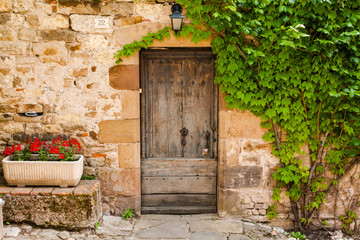 Fototapeta na wymiar Weathered doorway in old stone wall