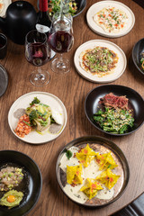 Set table in a fancy restaurant top view, various delicatessen meals