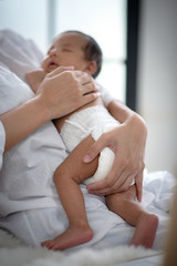 The baby is sleeping on a soft mattress