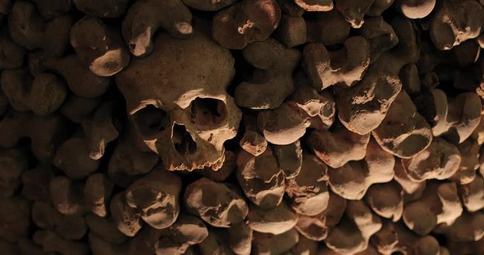 Wall made of human bones and skulls, dark spooky horror atmosphere